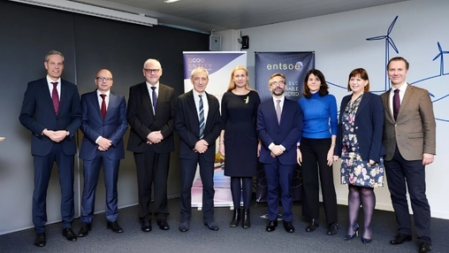 Group of nine professionals standing indoors at an energy sector event