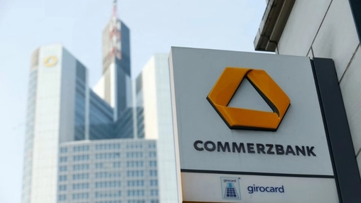 Close-up of the Commerzbank logo sign with the city skyline and Commerzbank Tower visible in the background